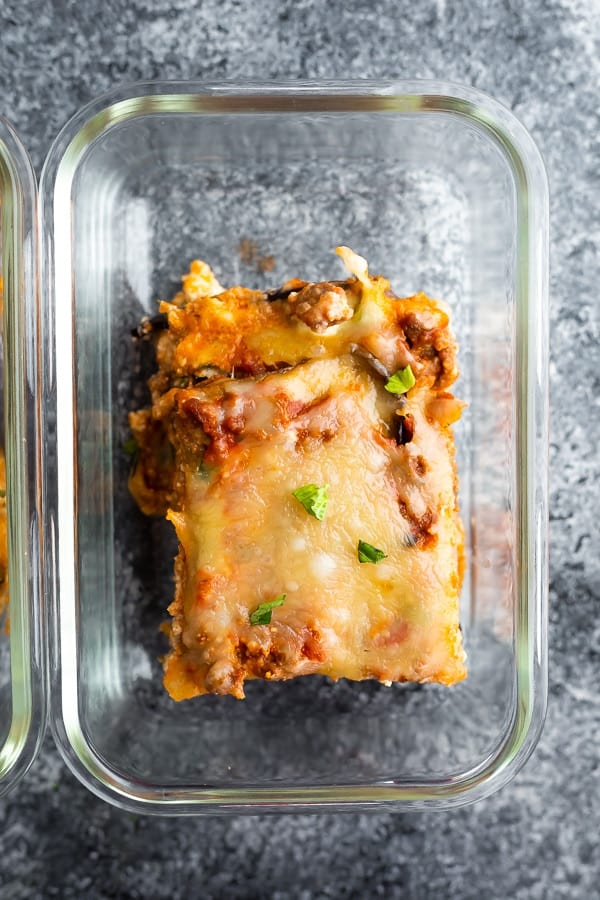 overhead view of a slice of eggplant lasagna recipe in a meal prep container