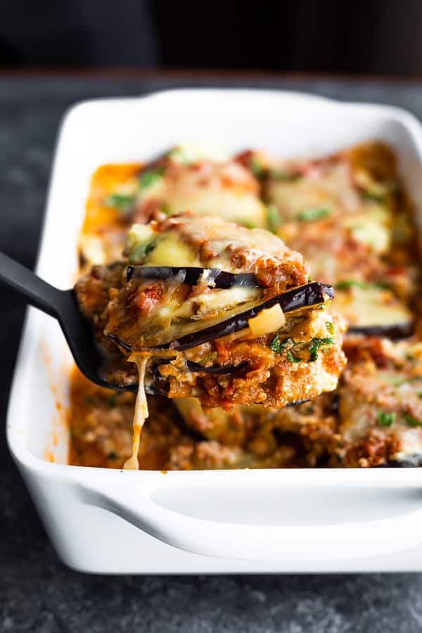 scooping a slice of the eggplant lasagna from the pan
