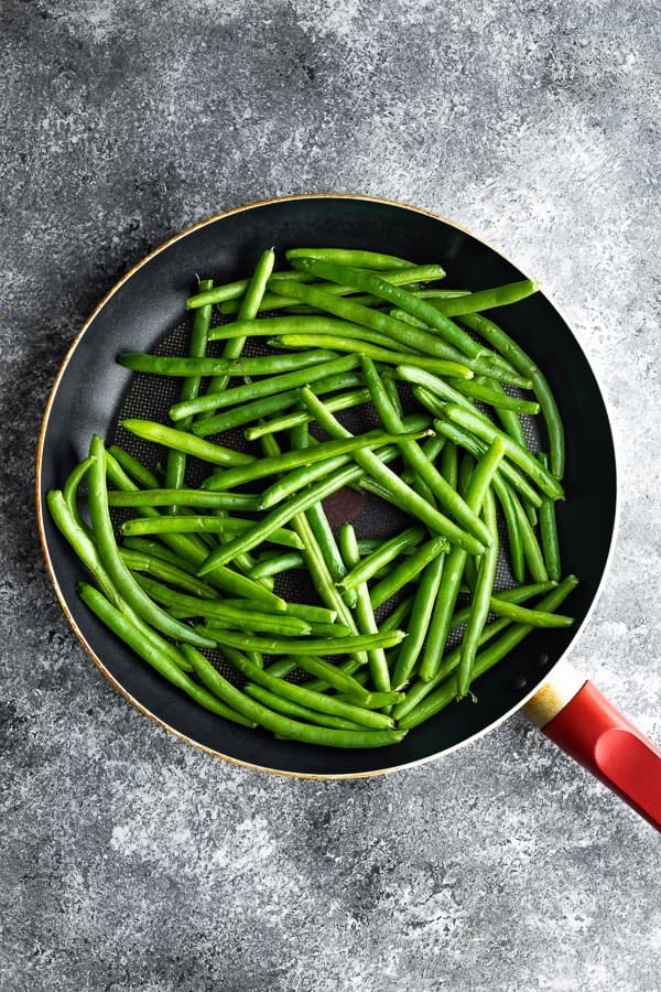 overhead view sauteed green beans recipe in frying pan
