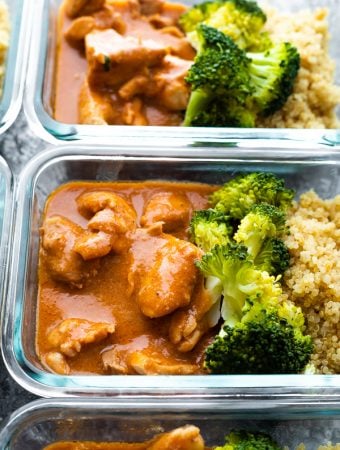 glass meal prep container filled with slow cooker butter chicken and broccoli