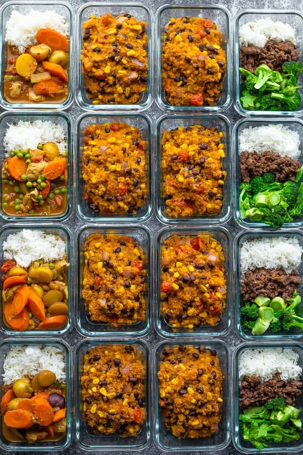 overhead shot of rows of glass meal prep containers with a variety of freezer friendly lunches