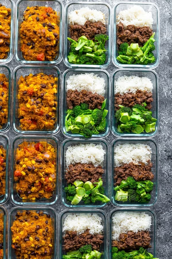 Overhead shot of rows of glass meal prep containers filled with freezer friendly lunch bowls