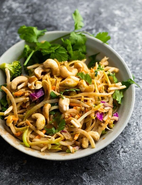Crunchy rainbow Thai salad in gray bowl with peanuts and cilantro