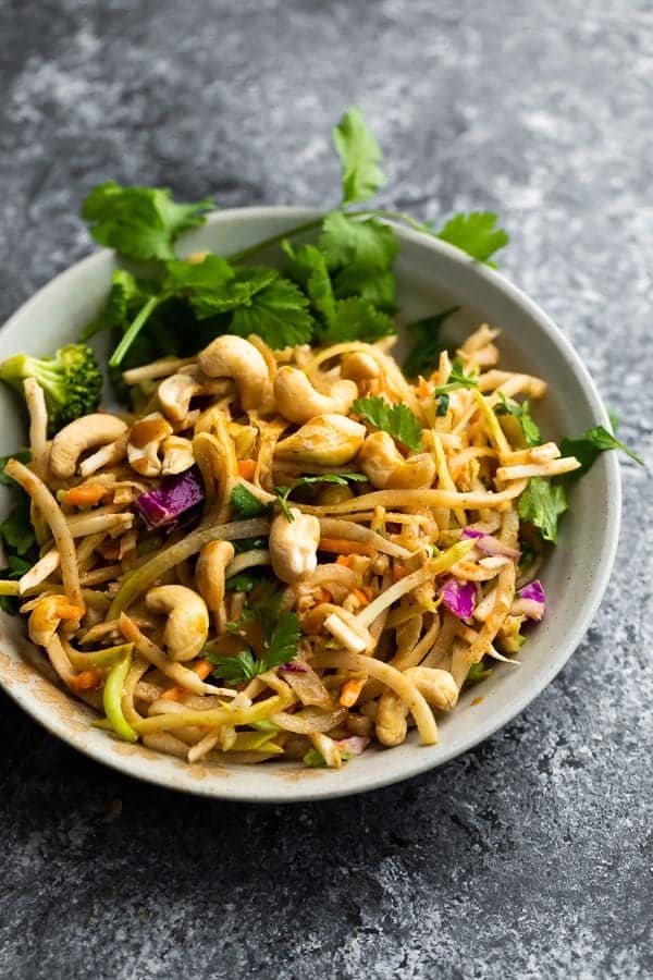 Crunchy rainbow Thai salad in gray bowl with peanuts and cilantro