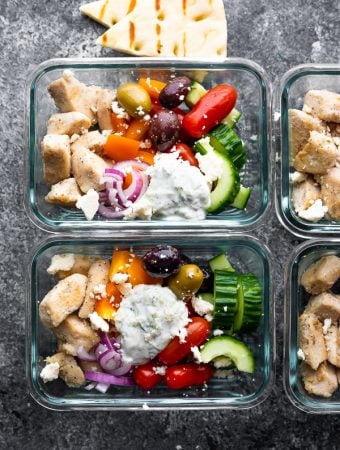 Overhead shot glass meal prep containers filled with Greek chicken meal prep bowls