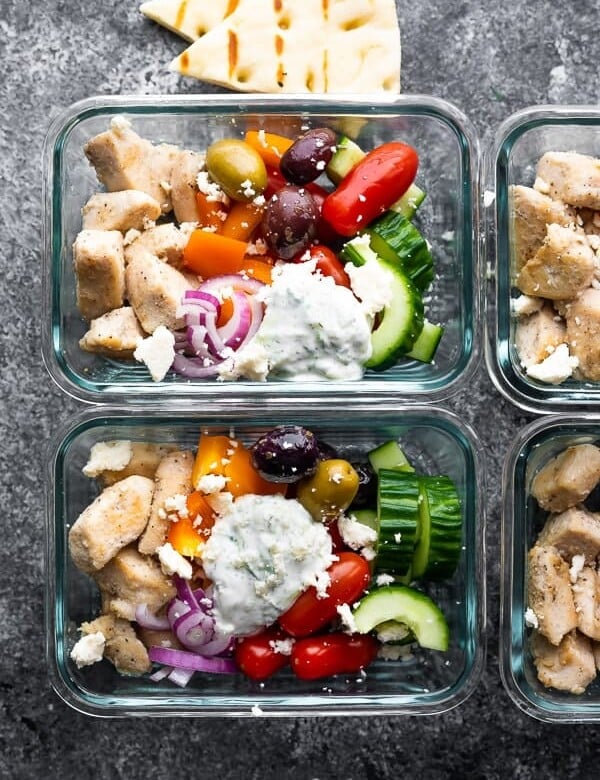 Overhead shot glass meal prep containers filled with Greek chicken meal prep bowls