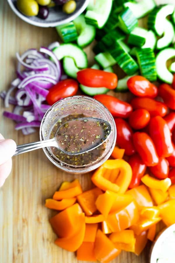showing the greek salad dressing recipe on a spoon
