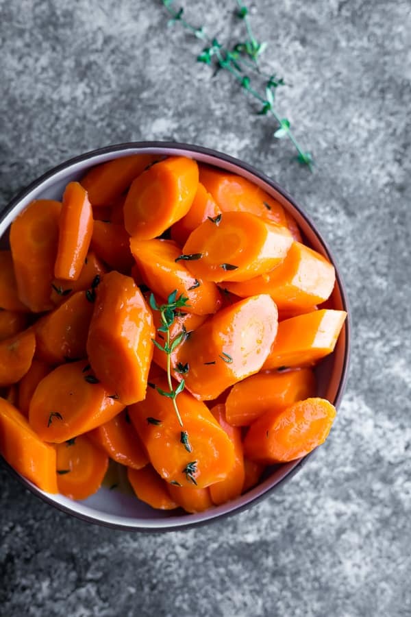 instant pot carrots recipe in bowl with fresh herbs