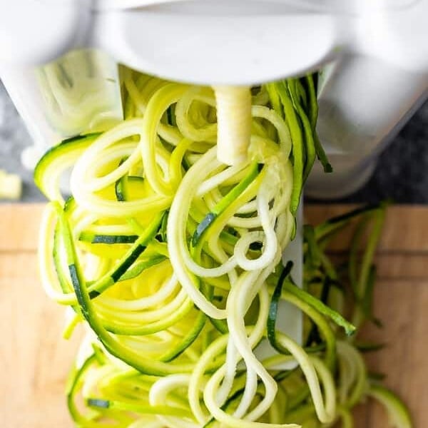 overhead shot of zucchini noodles coming out of spiralizer