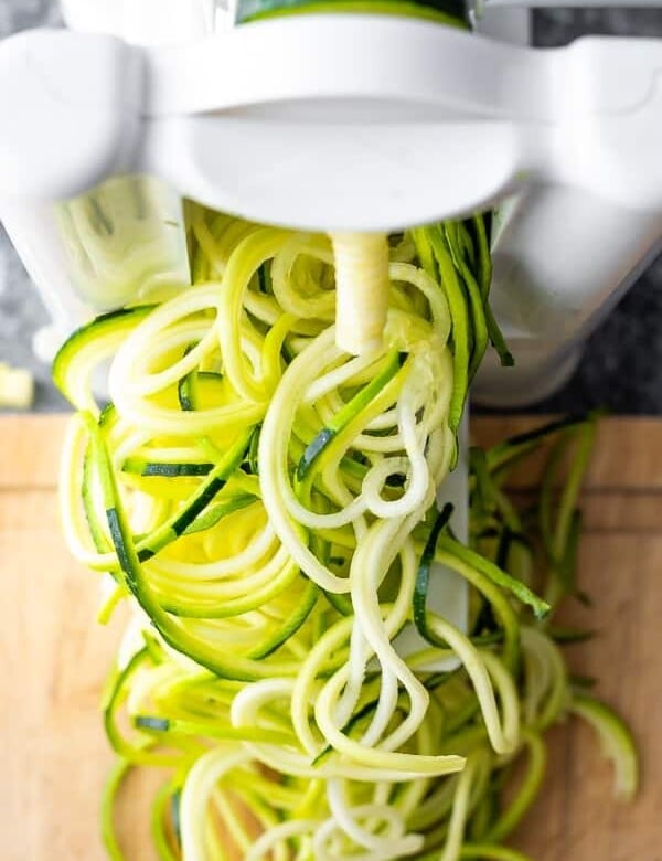 overhead shot of zucchini noodles coming out of spiralizer