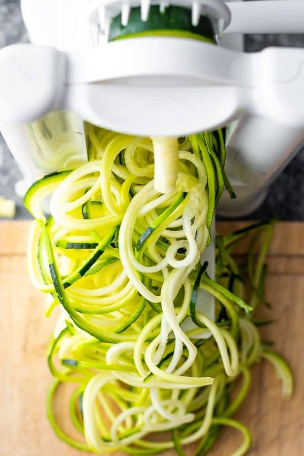 overhead shot of zucchini noodles coming out of spiralizer