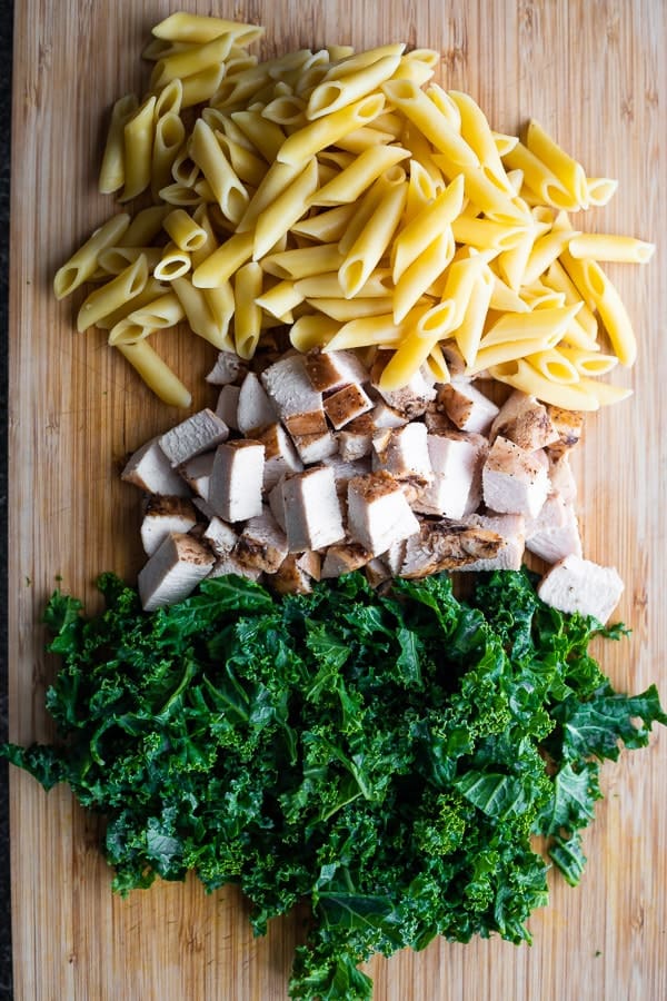 ingredients for healthy pasta salad on cutting board