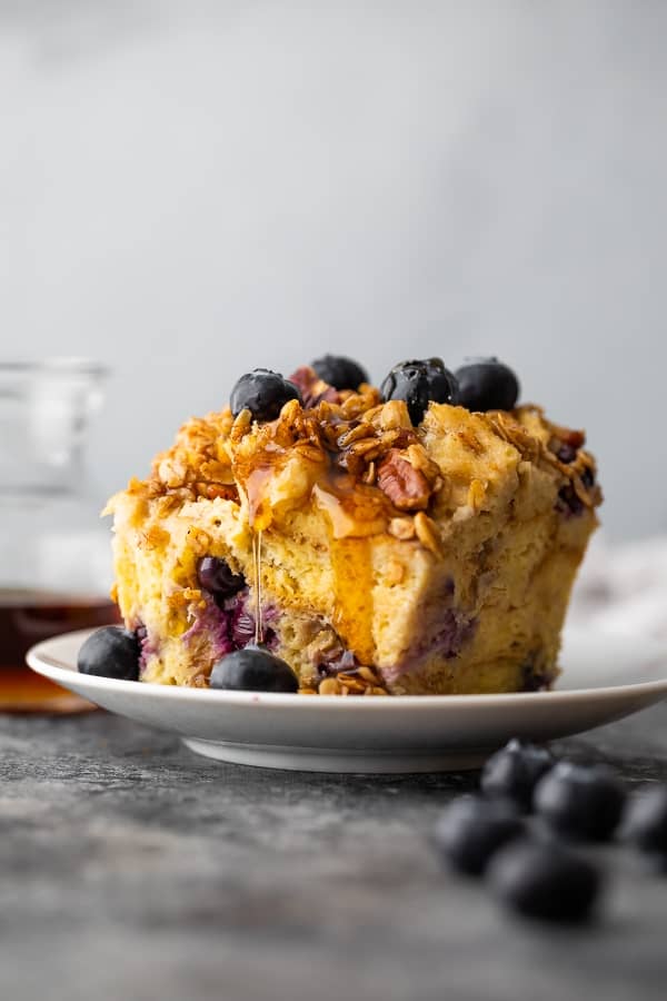 crockpot french toast casserole on plate with syrup dripping down