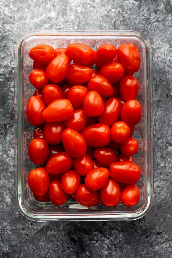 overhead shot of grape tomatoes in glass meal prep container