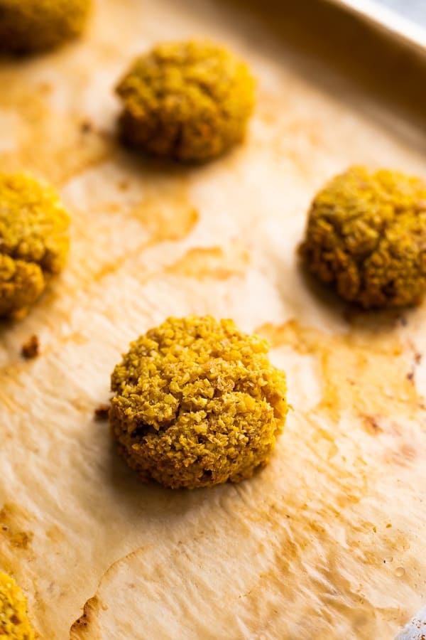 baked falafels on baking sheet after cooking