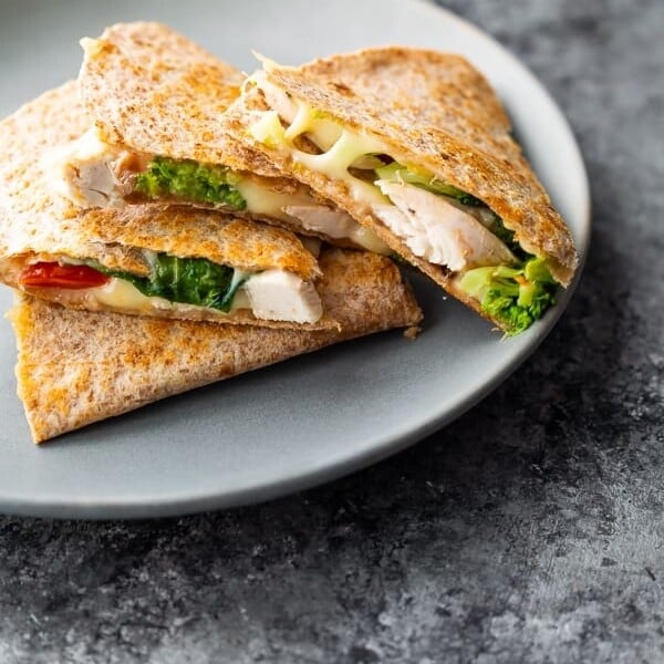 A stack of chicken quesadillas on a gray plate