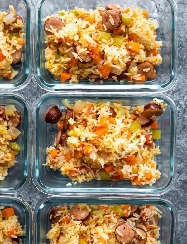 overhead shot of instant pot cajun rice and sausage in multiple glass meal prep containers