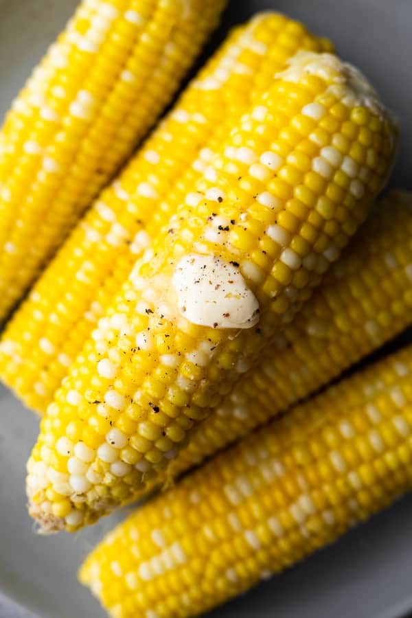 close up overhead view of instant pot corn on the cob with butter melting