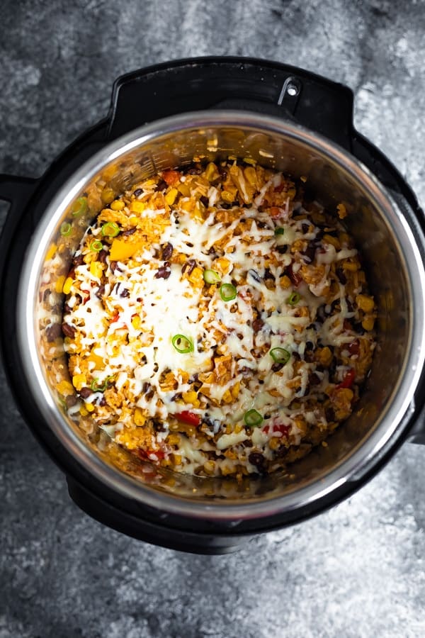 instant pot fiesta rice bowls after cooking, in instant pot with shredded cheese