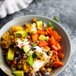 instant pot fiesta rice bowl in a gray bowl with avocado chunks and sliced green onion