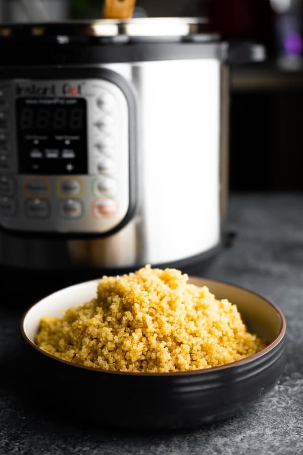 instant pot quinoa in a bowl with the instant pot in the background