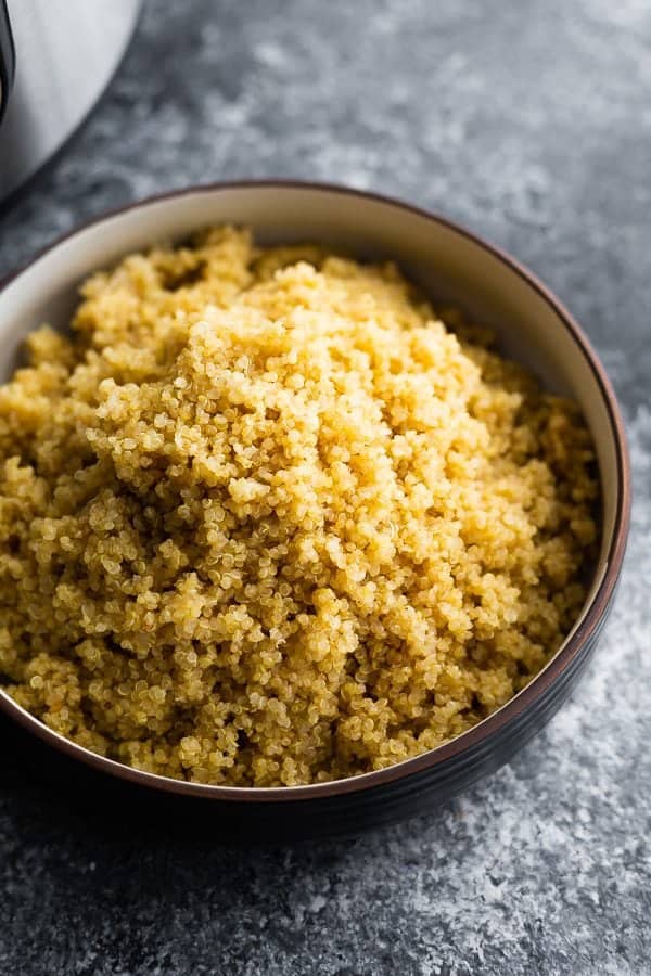 Large black bowl filled with instant pot quinoa