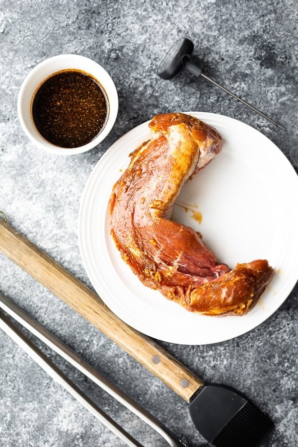 pork tenderloin on plate after marinating in best pork tenderloin marinade