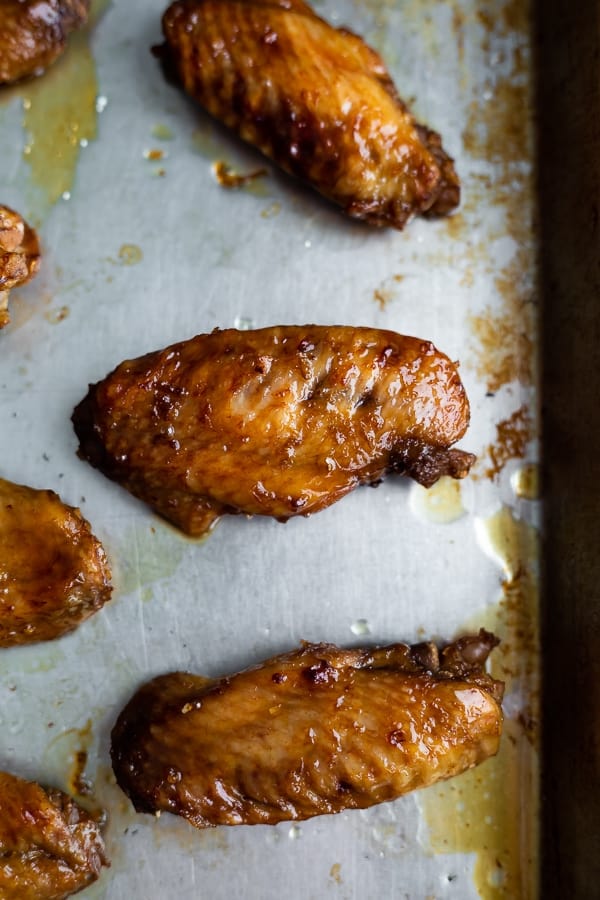 overhead view of a easy slow cooker chicken wings recipe on sheet pan after broiling.