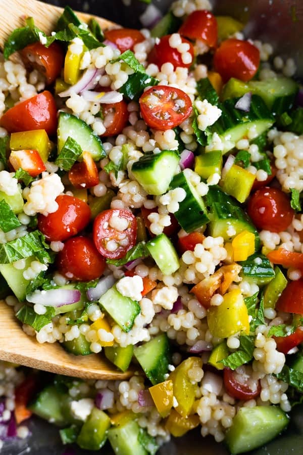 close up of mediterranean couscous salad tossed in dressing