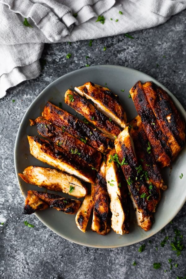 overhead view of grilled chicken on grey plate