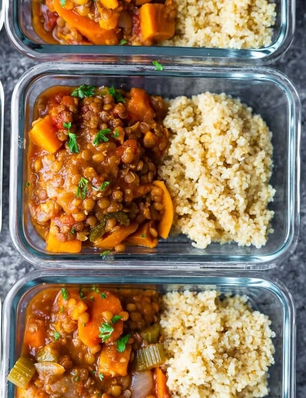 overhead shot of glass meal prep container filled with moroccan instant pot lentils and rice