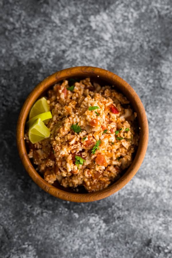 overhead view of mexican cauliflower rice skillet in wooden bowl