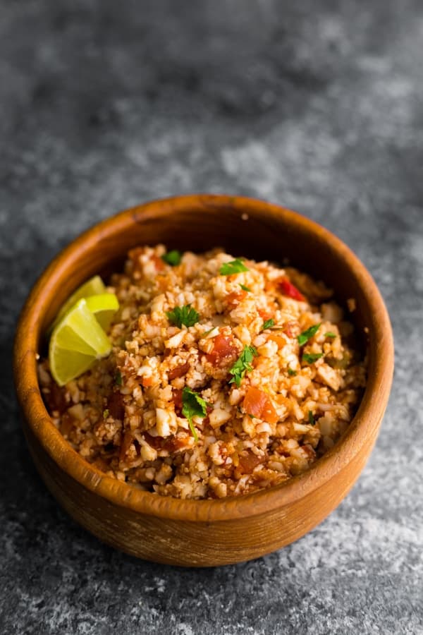 side angle view of mexican cauliflower rice in wooden bowl