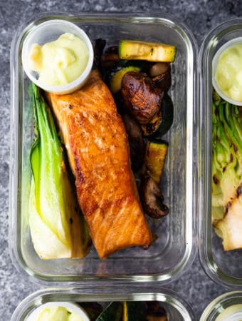 glass container filled with wasabi grilled salmon bowls and sauce