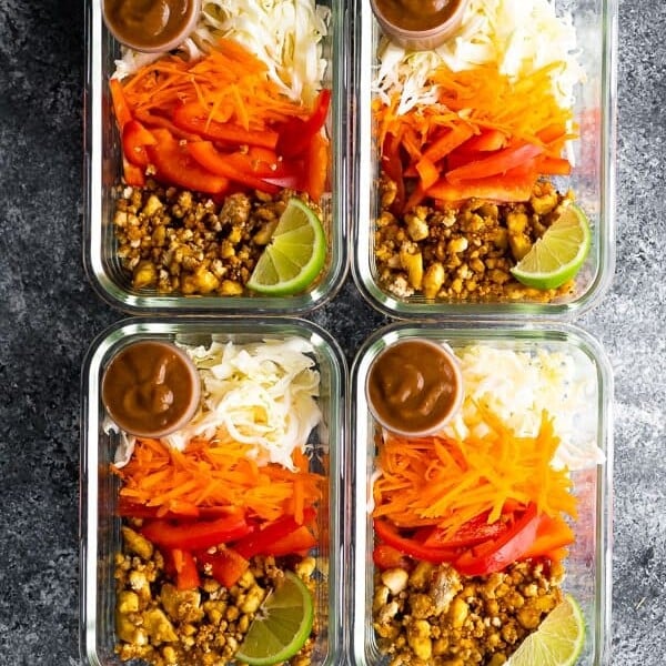 overhead shot of four glass containers filled with tofu spring roll bowls