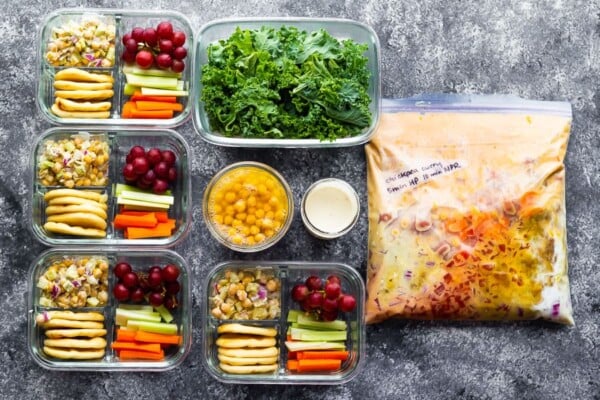 overhead shot of variety of foods in meal prep containers and freezer bag