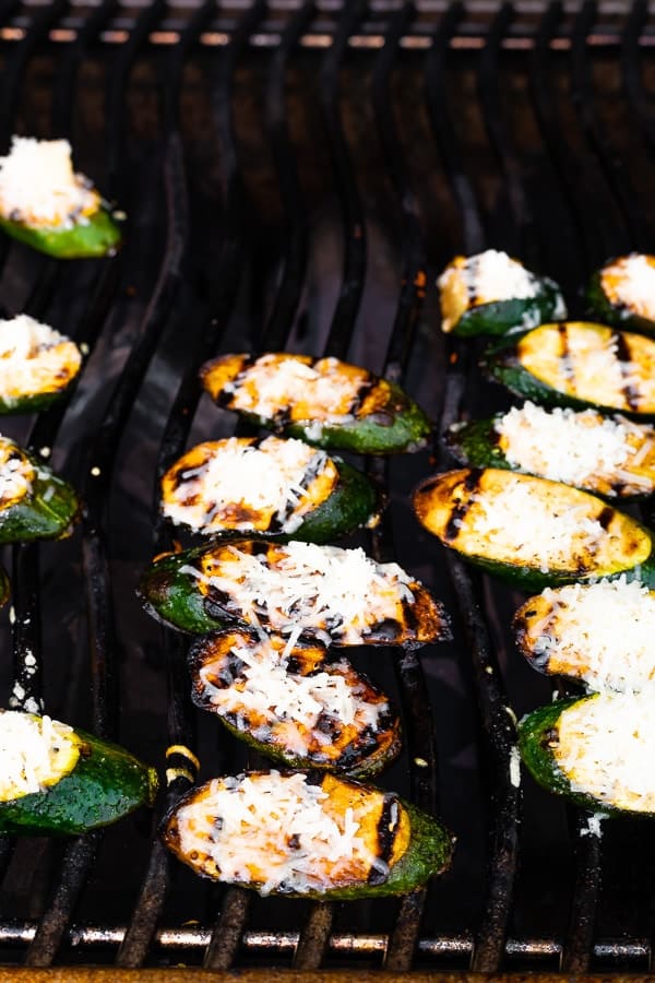parmesan cheese on the balsamic grilled zucchini on the barbecue