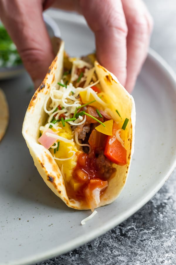 hand holding breakfast tacos recipe