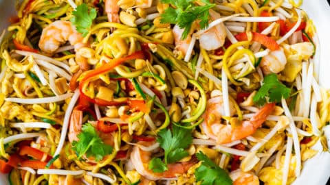 overhead shot of zucchini noodle pad thai in large white bowl