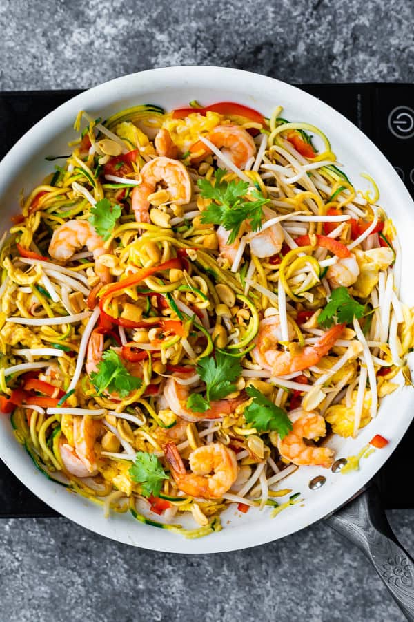 overhead shot of zucchini noodle pad thai in large white bowl