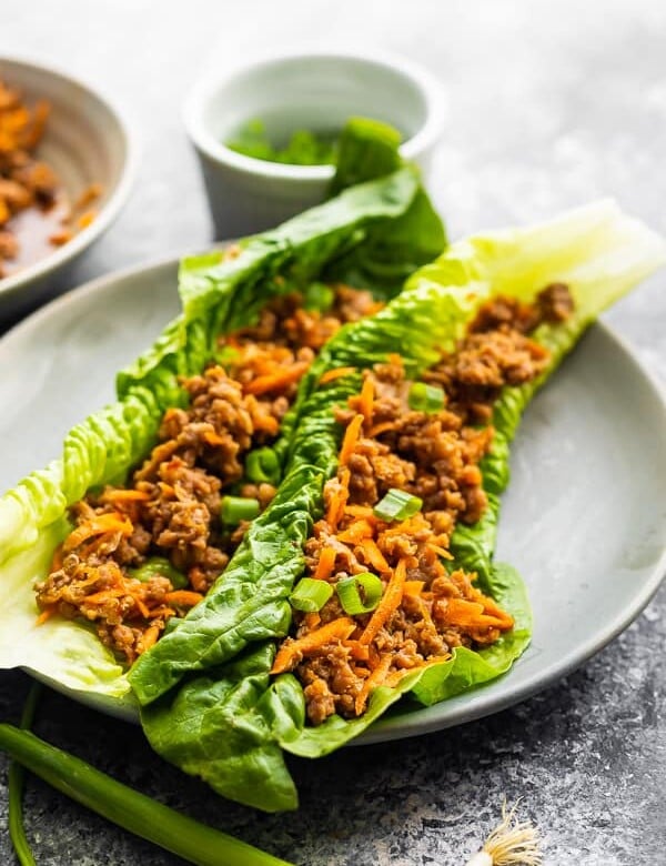 two asian ground turkey lettuce wraps on gray plate