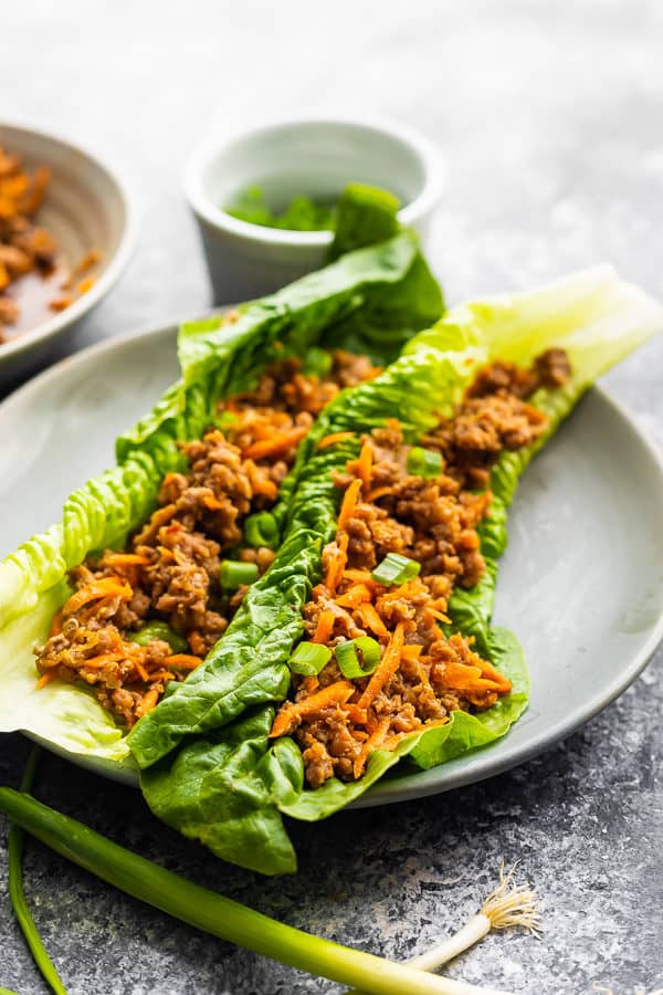 two asian ground turkey lettuce wraps on gray plate