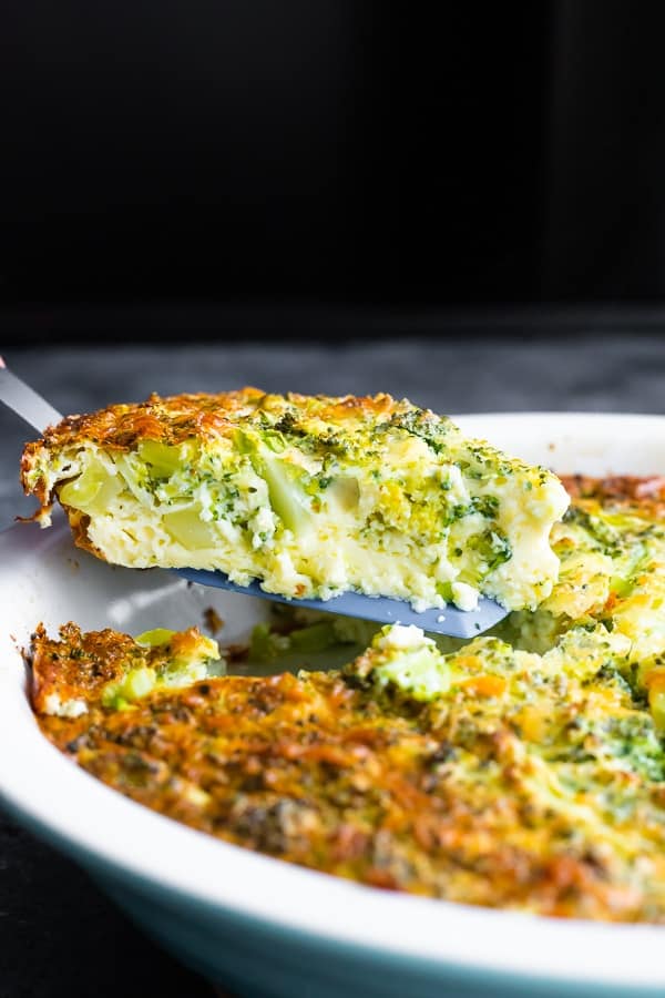 slice of crustless quiche recipe on spatula lifting out of pie plate