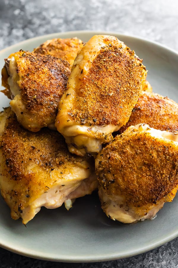 plate full of oven baked chicken thighs, close up