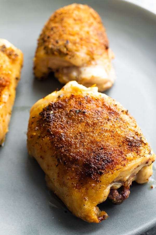 close up of baked chicken thighs on plate