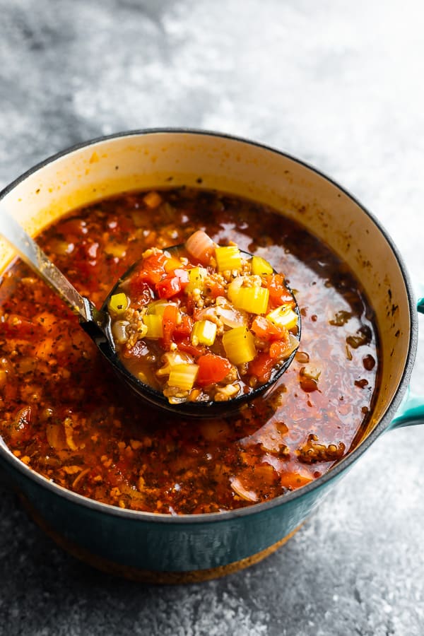 scooping the italian sausage soup with soup ladle