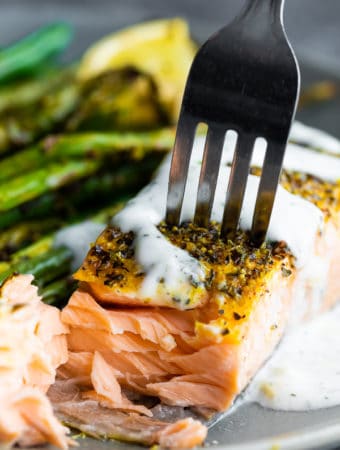 fork taking a bite out of the lemon pepper salmon