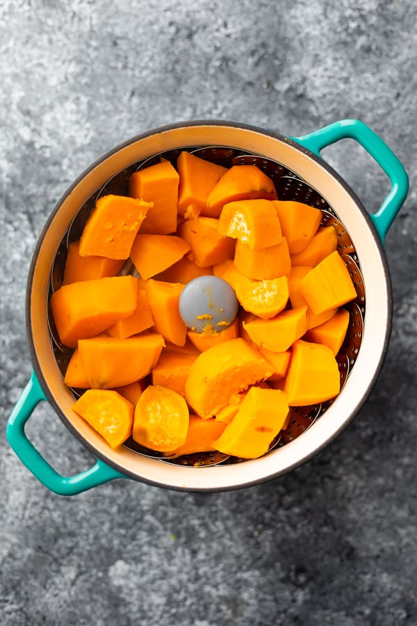 sweet potato chunks in steamer basket after cooking for mashed sweet potatoes