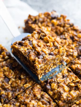 a spatula picking of a slice of no bake snack bars
