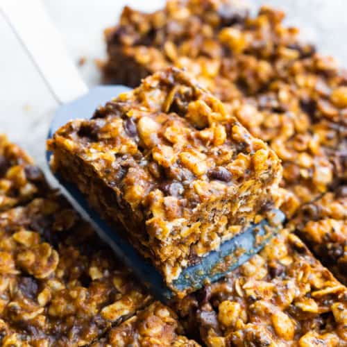 a spatula picking of a slice of no bake snack bars